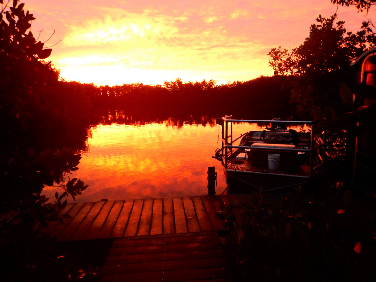 Red sky at morning: soaking up an early morning view of a fire-red sunrise from the dock at Canepatch backcountry campsite.